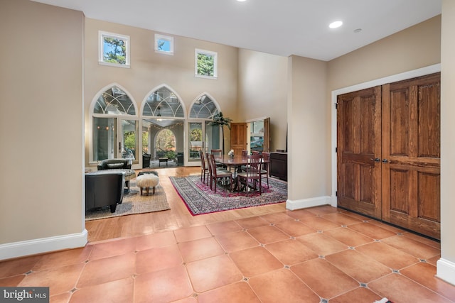 tiled foyer with a high ceiling