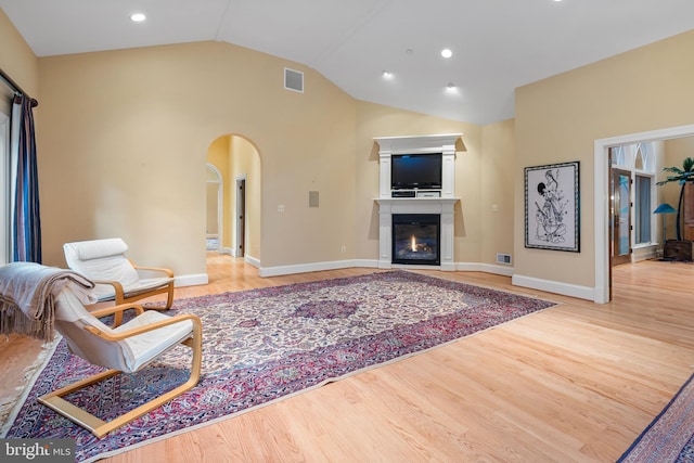 living room with vaulted ceiling and light hardwood / wood-style floors