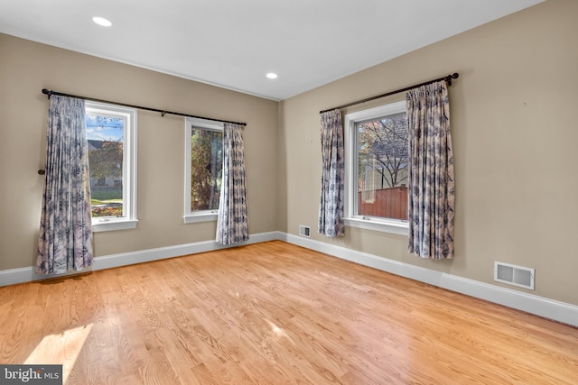 unfurnished room with light hardwood / wood-style floors