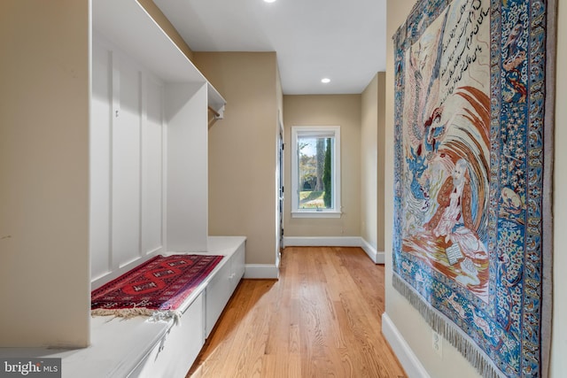 mudroom with light hardwood / wood-style floors