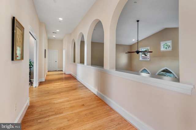 hall featuring vaulted ceiling and light hardwood / wood-style floors