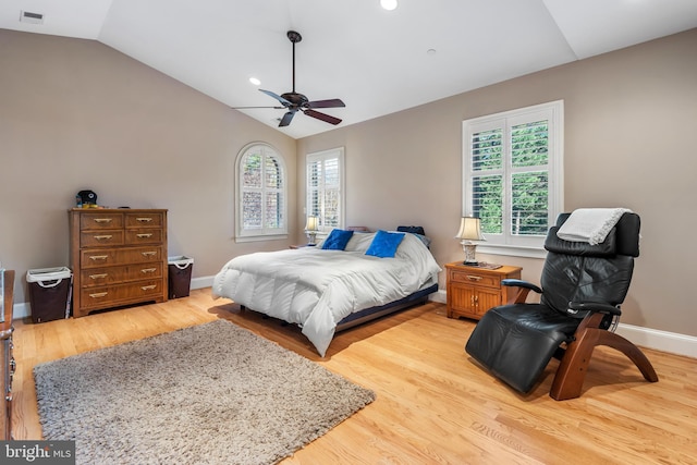 bedroom with multiple windows, wood-type flooring, lofted ceiling, and ceiling fan