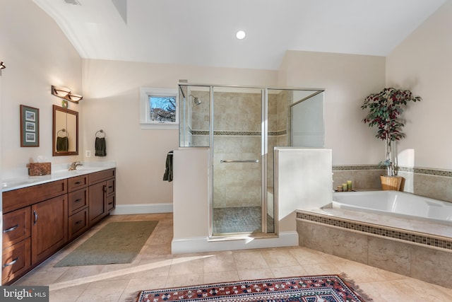 bathroom with tile patterned flooring, vanity, and separate shower and tub