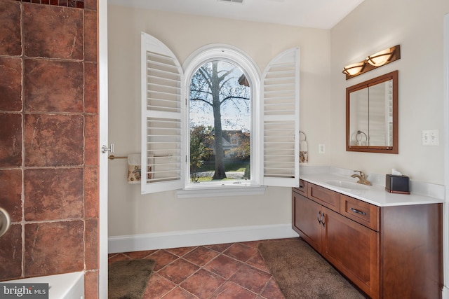 bathroom with plenty of natural light, tile patterned flooring, and vanity