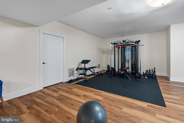 workout area with hardwood / wood-style floors