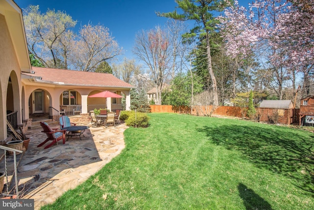 view of yard with a shed and a patio