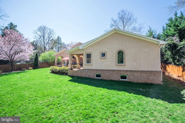 rear view of property with a yard