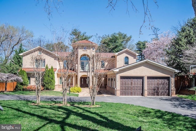 mediterranean / spanish home with a garage and a front yard