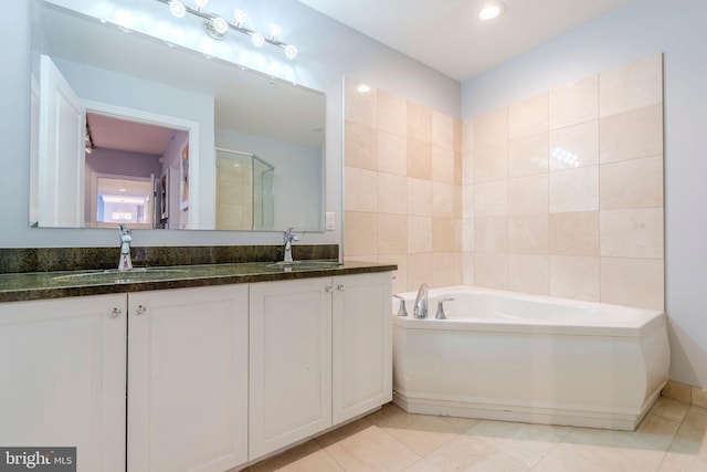 bathroom featuring shower with separate bathtub, tile patterned floors, and vanity