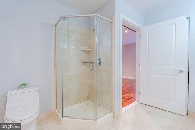 bathroom with walk in shower, toilet, and tile patterned flooring