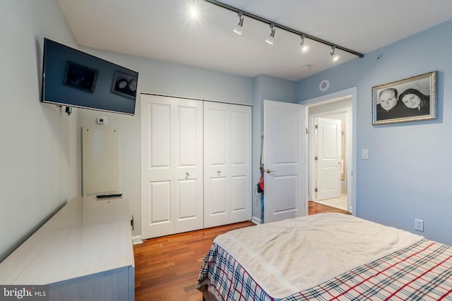 bedroom with hardwood / wood-style flooring and a closet