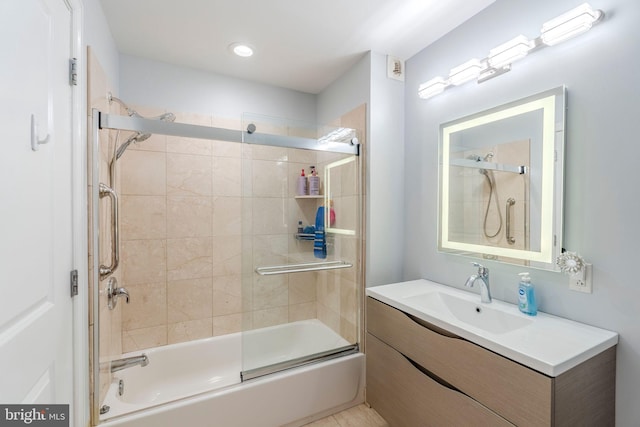 bathroom with vanity and bath / shower combo with glass door