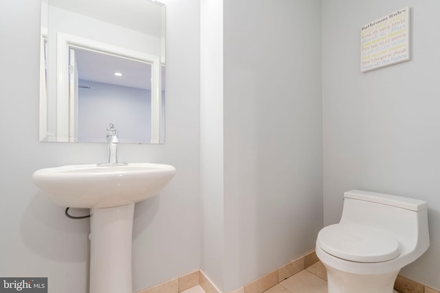 bathroom with tile patterned flooring and toilet