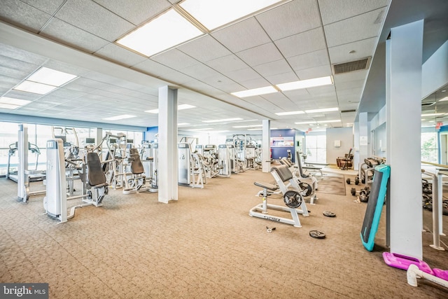 workout area with a drop ceiling and plenty of natural light