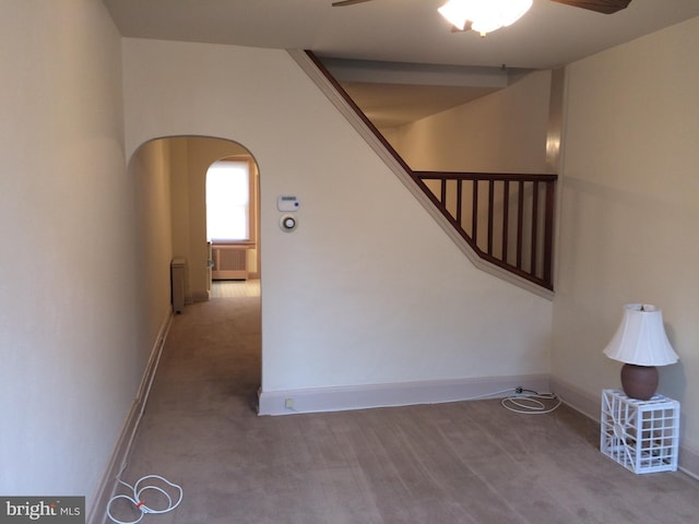 interior space featuring carpet floors and ceiling fan