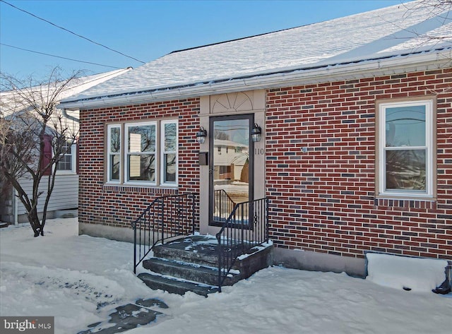 view of snow covered property entrance