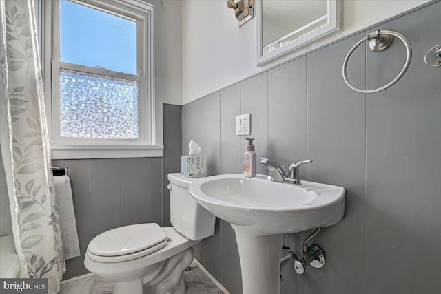 bathroom featuring walk in shower, a healthy amount of sunlight, and toilet