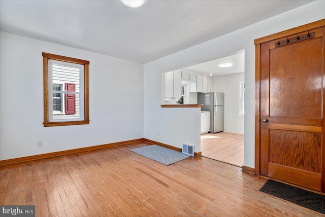 unfurnished living room with light hardwood / wood-style flooring