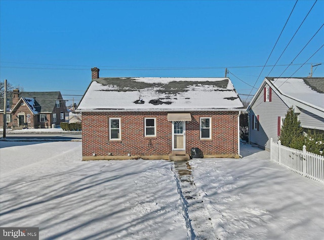 view of snow covered rear of property