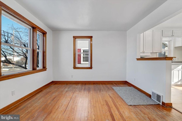 interior space with plenty of natural light and light hardwood / wood-style floors