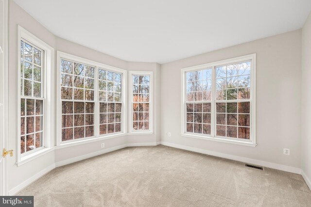 unfurnished sunroom featuring visible vents