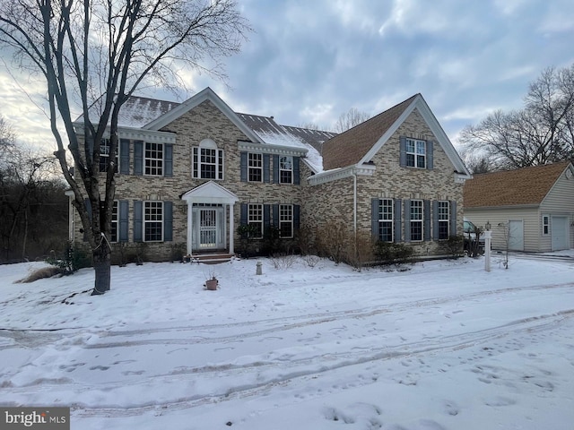 view of front of house featuring a garage, stone siding, and brick siding