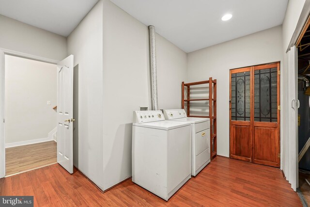 laundry area featuring laundry area, separate washer and dryer, wood finished floors, and recessed lighting