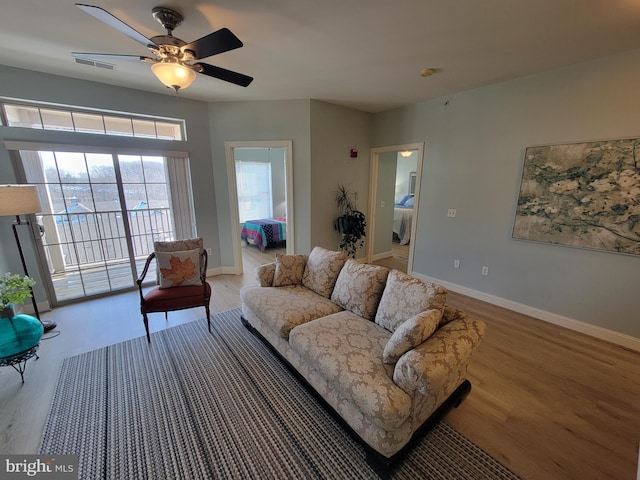 living room with hardwood / wood-style flooring and ceiling fan