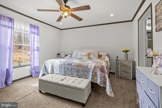 carpeted bedroom featuring crown molding and ceiling fan