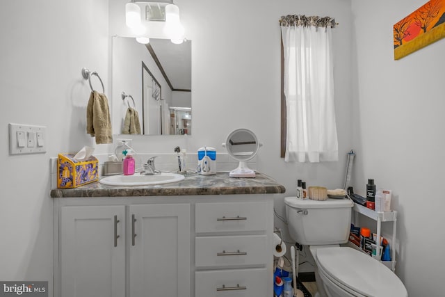 bathroom featuring vanity and toilet