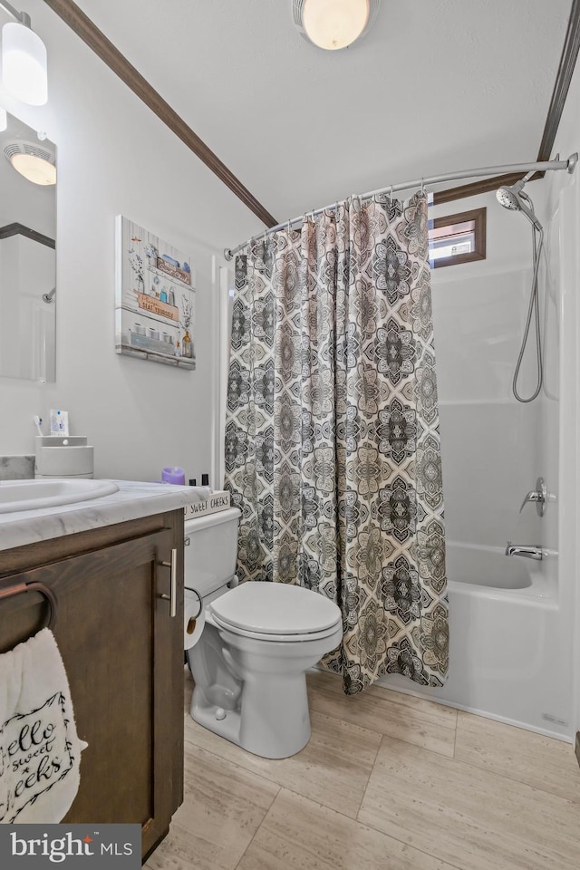 full bathroom with crown molding, vanity, toilet, and shower / tub combo