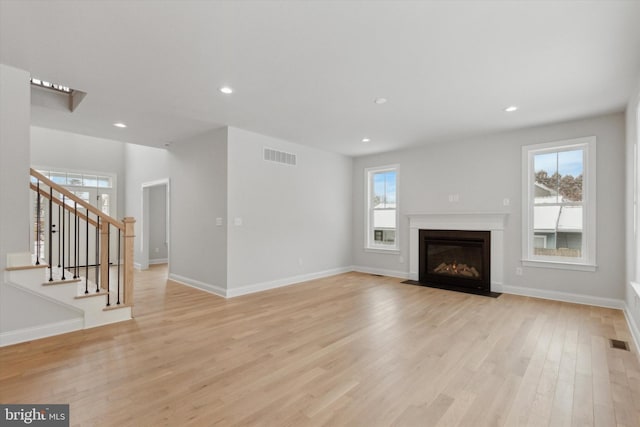 unfurnished living room with light wood-type flooring