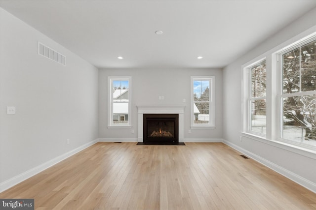 unfurnished living room with light wood-type flooring