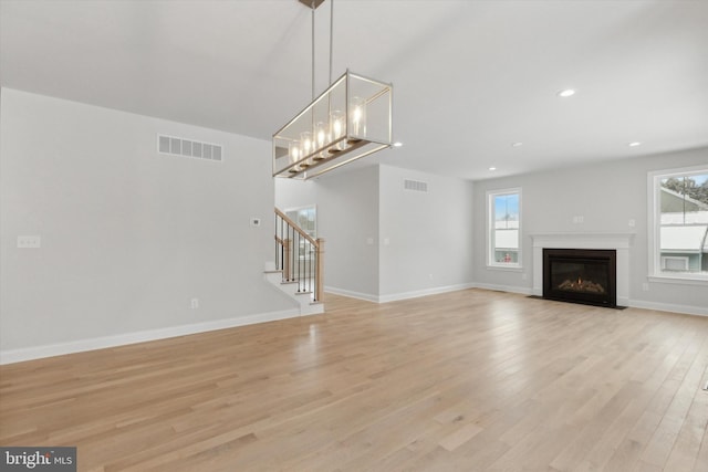 unfurnished living room with light wood-type flooring