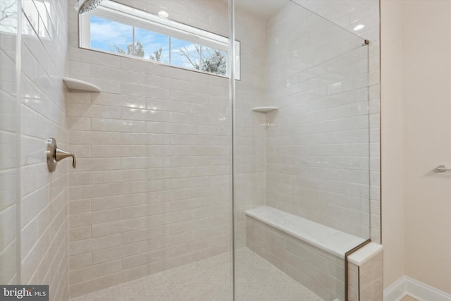 bathroom with tiled shower