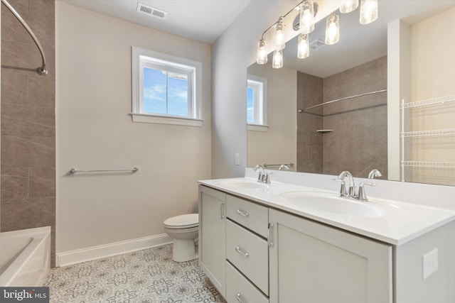 full bathroom with vanity, toilet, tiled shower / bath combo, and tile patterned flooring