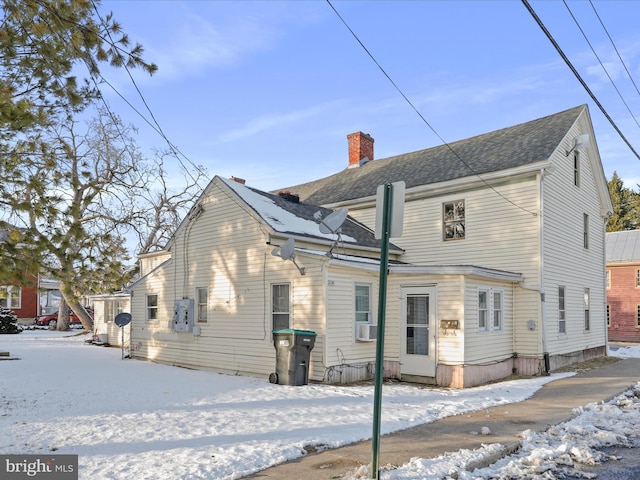 snow covered property featuring cooling unit