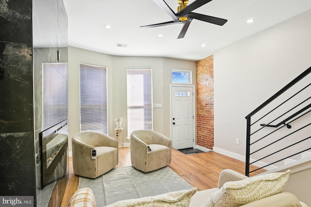 living room featuring wood-type flooring and ceiling fan