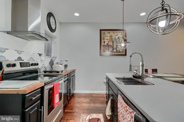 kitchen with dishwashing machine, sink, hanging light fixtures, stainless steel electric stove, and wall chimney exhaust hood