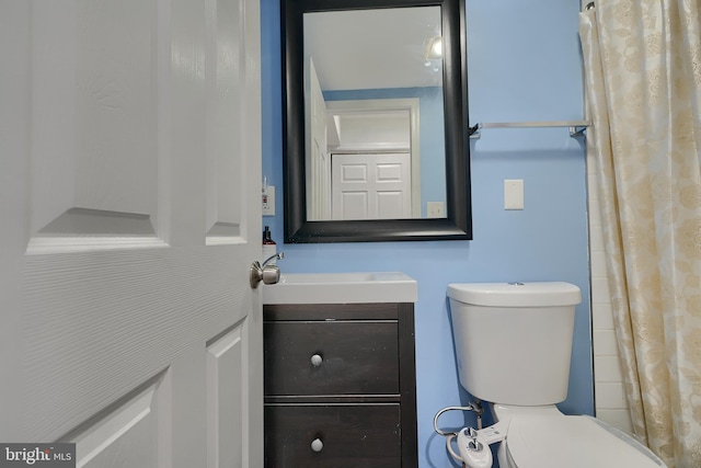 bathroom featuring vanity and toilet