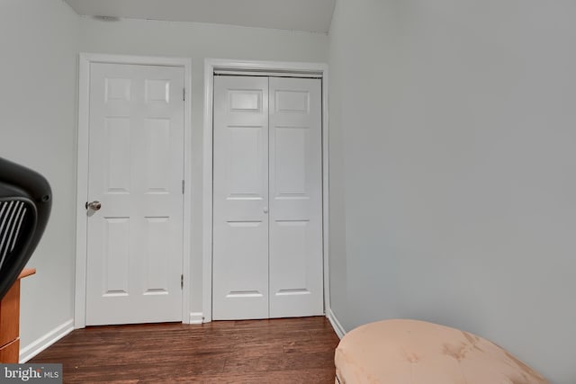 bedroom with dark wood-type flooring