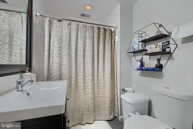 bathroom with sink, curtained shower, and toilet