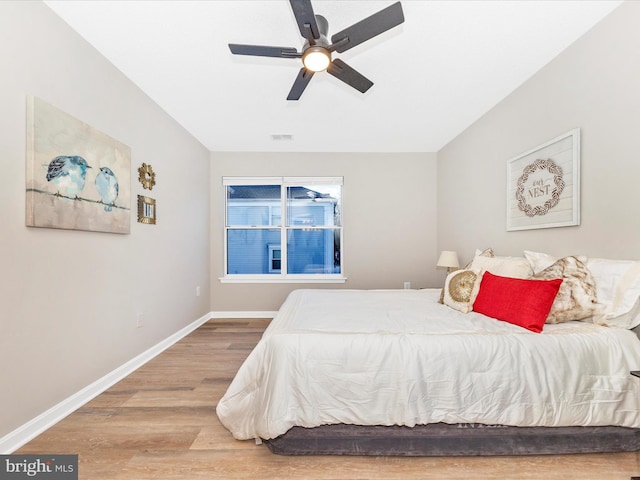 bedroom with hardwood / wood-style floors and ceiling fan