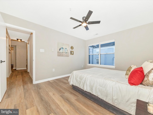 bedroom with light wood-type flooring and ceiling fan