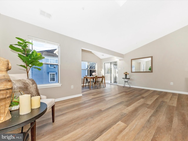 sitting room with vaulted ceiling and light hardwood / wood-style floors