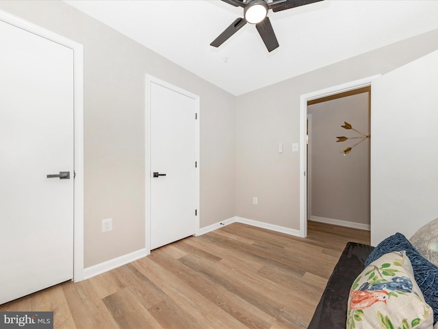 unfurnished bedroom featuring hardwood / wood-style floors and ceiling fan