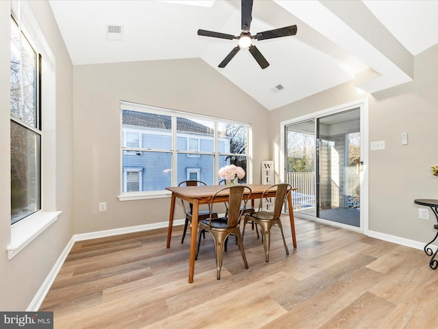 dining room with vaulted ceiling, ceiling fan, and light wood-type flooring