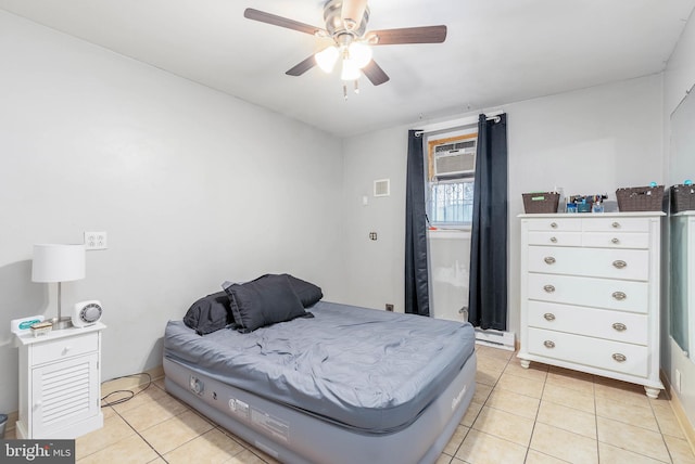 tiled bedroom with ceiling fan and a wall mounted AC