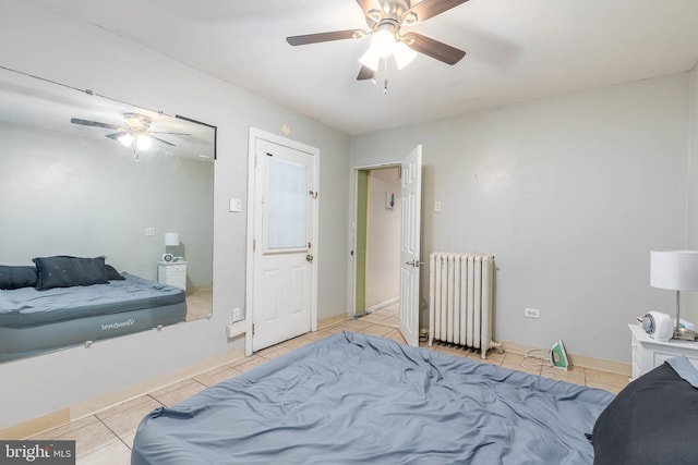 bedroom featuring radiator heating unit, ceiling fan, and light tile patterned floors