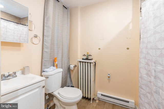 bathroom featuring hardwood / wood-style flooring, baseboard heating, radiator heating unit, vanity, and toilet